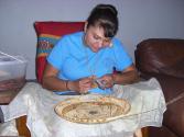 The artist creating the basket.