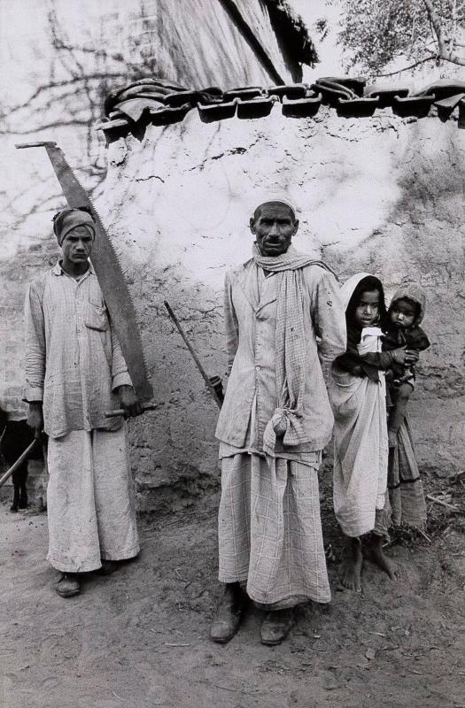 Two Men, One With Saw, and Two Children, India